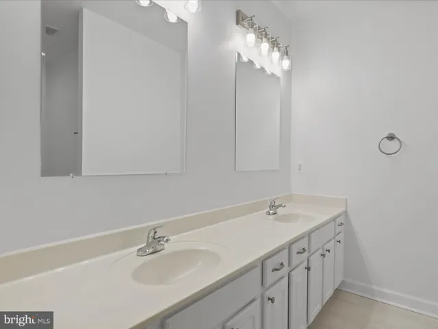 a bathroom with a sink vanity and a mirror