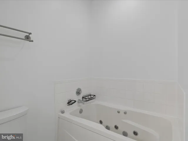 a bathroom with a bathtub and toilet