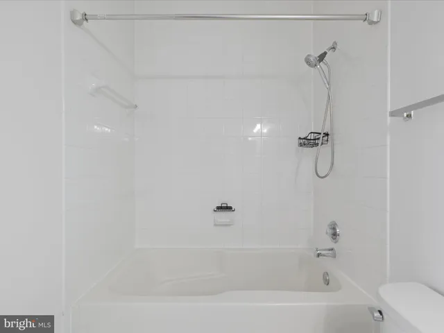 a bathroom with a bath tub with a shower