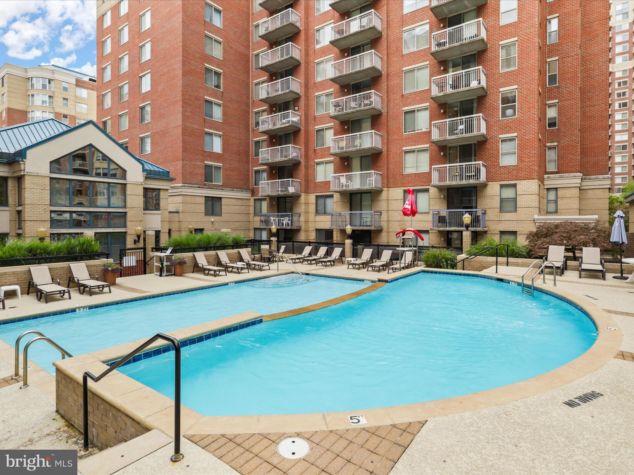 3830 9th Street North, Unit PH3E Arlington, VA 22203 - Photo 37 of 44 a view of a swimming pool with a lounge chairs