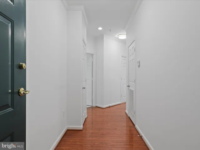 a view of hallway with wooden floor