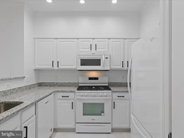 a kitchen with stainless steel appliances granite countertop a stove and a sink