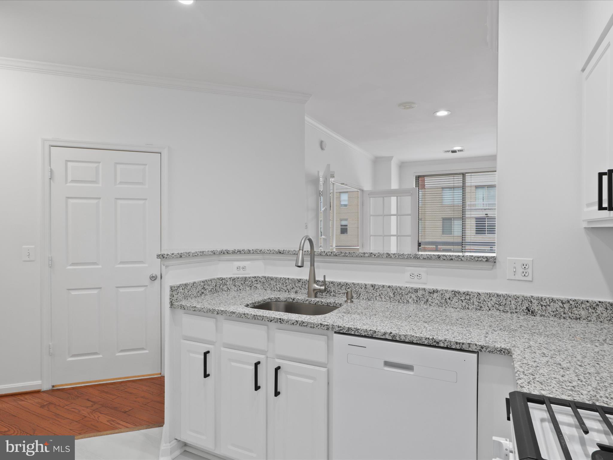 3830 9th Street North, Unit PH3E Arlington, VA 22203 - Photo 8 of 44 a bathroom with a granite countertop sink and a mirror