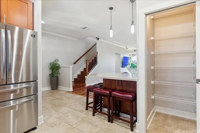 a view of hallway with furniture and a refrigerator