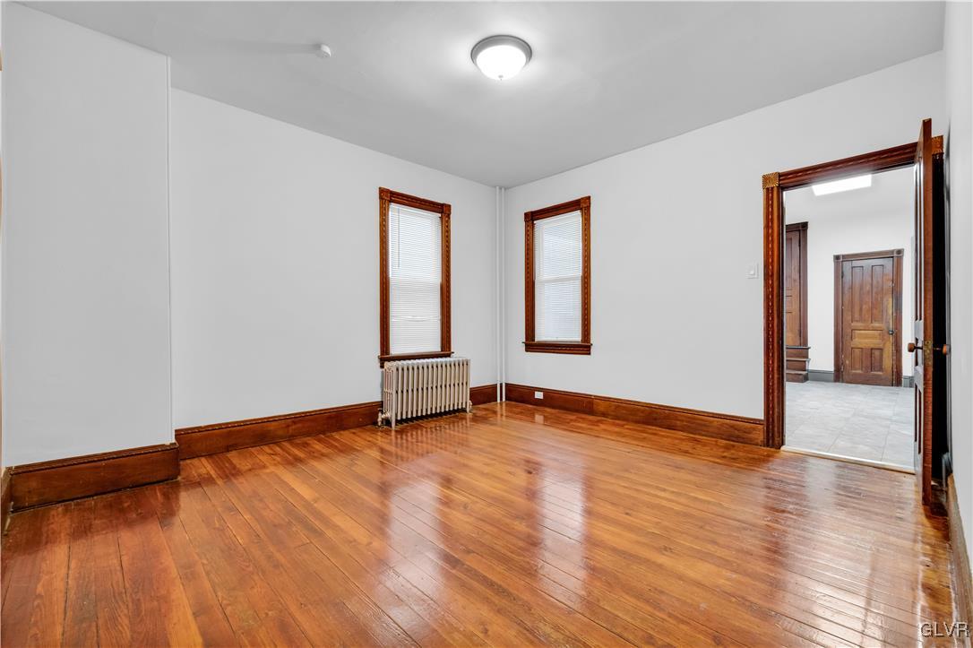 911 Spring Garden Street Easton, PA 18042 - Photo 11 of 48 an empty room with wooden floor and windows