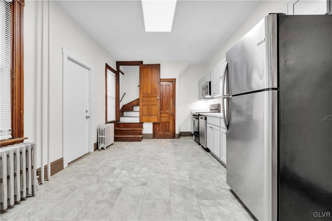 911 Spring Garden Street Easton, PA 18042 - Photo 13 of 48 a view of a kitchen with a refrigerator a sink dishwasher and a refrigerator