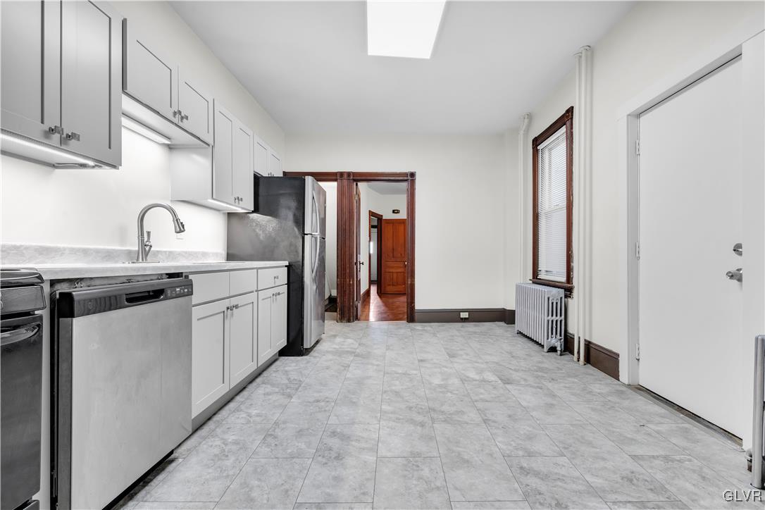 911 Spring Garden Street Easton, PA 18042 - Photo 14 of 48 a kitchen with stainless steel appliances granite countertop a sink and a refrigerator