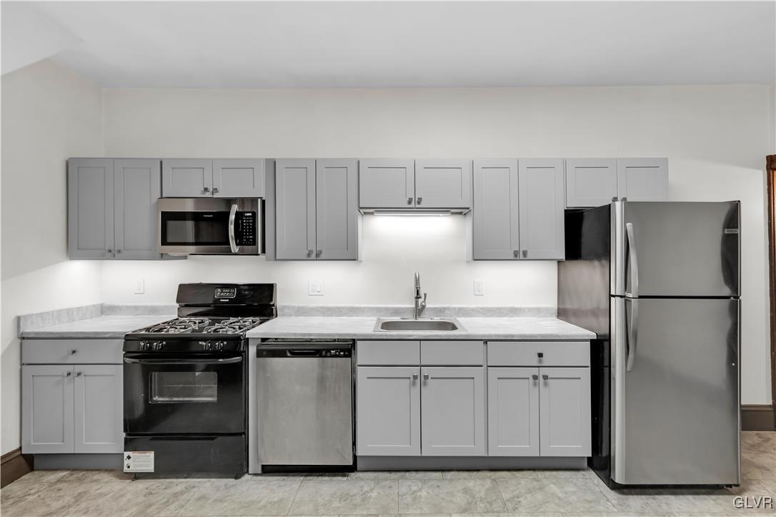 911 Spring Garden Street Easton, PA 18042 - Photo 15 of 48 a kitchen with appliances a sink and lots of appliances