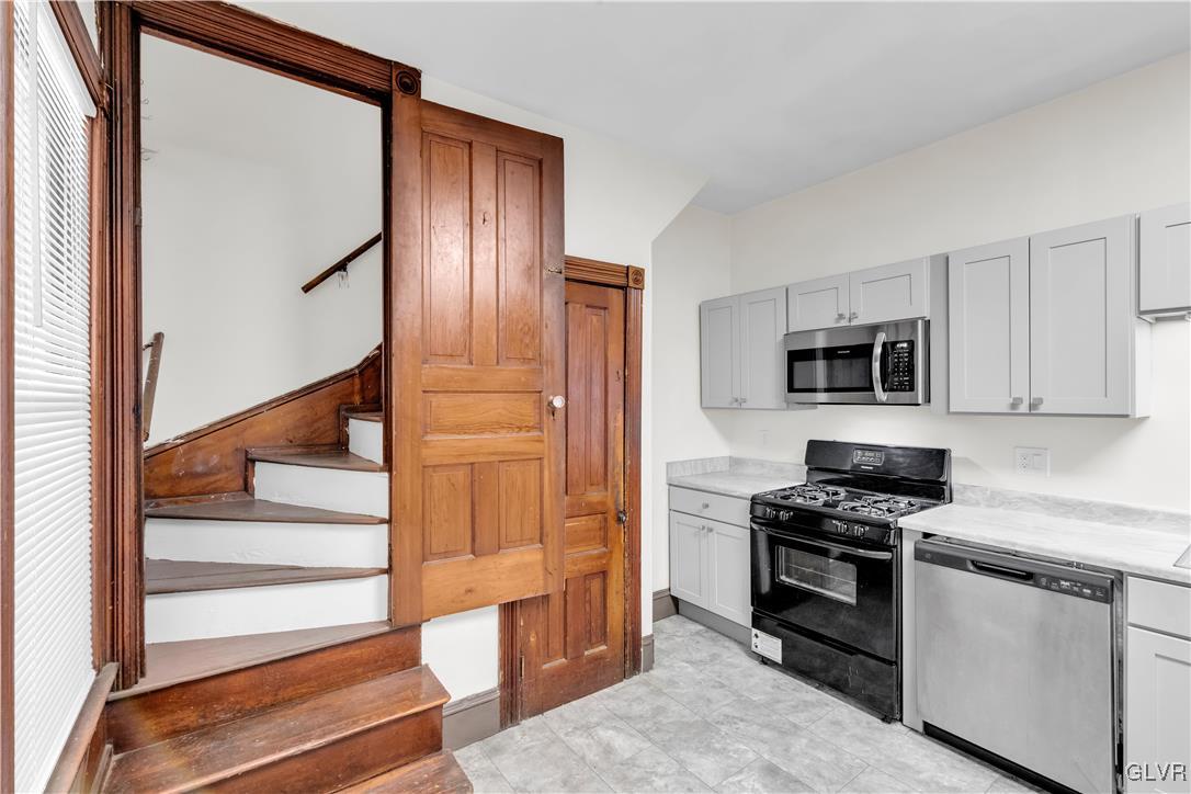 911 Spring Garden Street Easton, PA 18042 - Photo 16 of 48 a kitchen with stainless steel appliances granite countertop a stove and a refrigerator