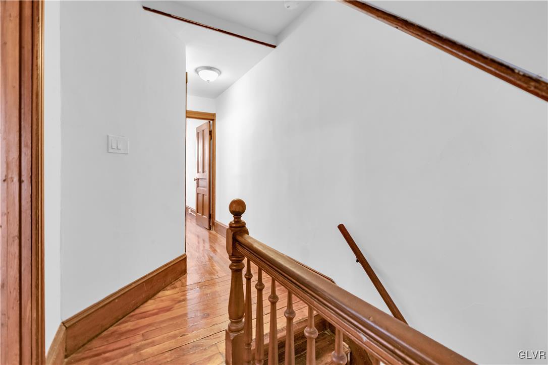 911 Spring Garden Street Easton, PA 18042 - Photo 24 of 48 a view of a hallway with wooden floor and stairs