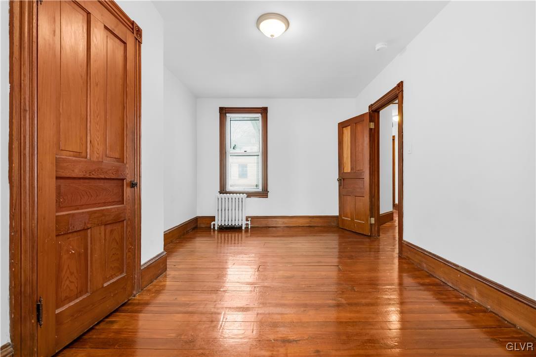 911 Spring Garden Street Easton, PA 18042 - Photo 28 of 48 a view of an empty room with window and wooden floor