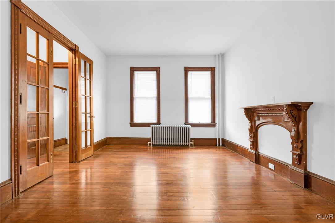 911 Spring Garden Street Easton, PA 18042 - Photo 8 of 48 an empty room with wooden floor and windows