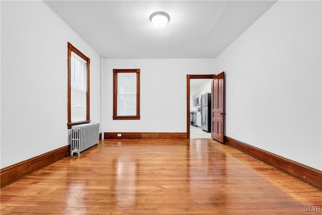 911 Spring Garden Street Easton, PA 18042 - Photo 9 of 48 a view of an empty room with window and wooden floor