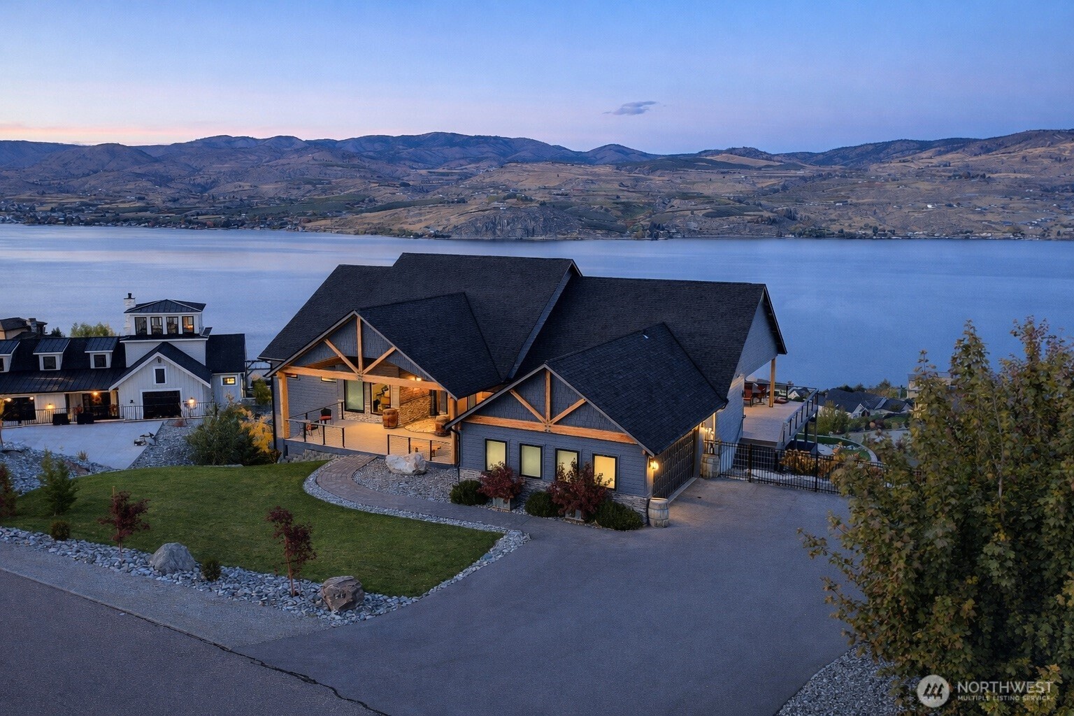 149 Clos Chevalle Road Chelan, WA 98816 - Photo 2 of 37 a front view of a house with a yard and a large tree