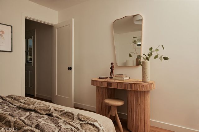 a bedroom with a bed and a mirror