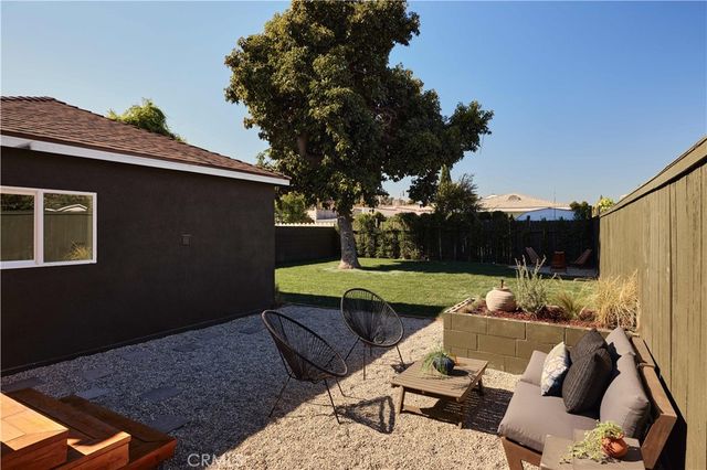 a view of backyard of house with seating space