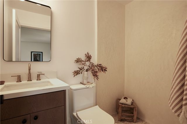 a bathroom with a sink a toilet and mirror