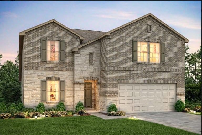 a front view of a house with a yard and garage