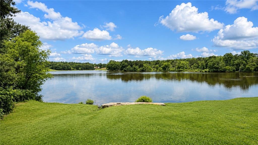6936 Red Bone Way Stonecrest, GA 30038 - Photo 17 of 17 a view of a lake with houses in the back