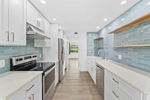 a kitchen with a sink stove and refrigerator