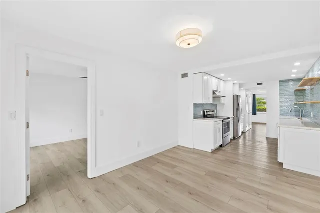 a kitchen with a refrigerator and a stove top oven