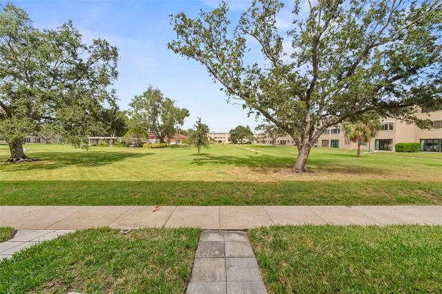 front view of a brick house with a yard