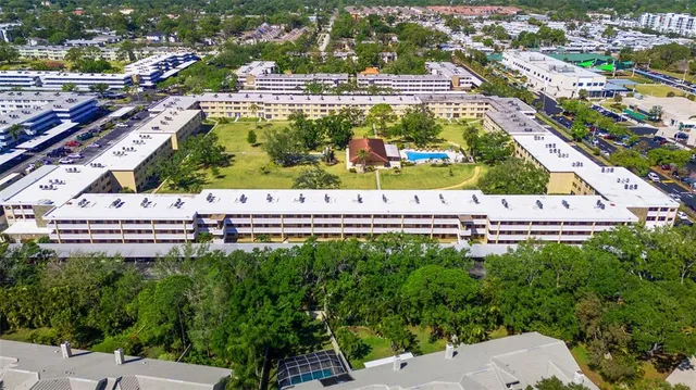 a view of a patio with a table and chairs under an umbrella