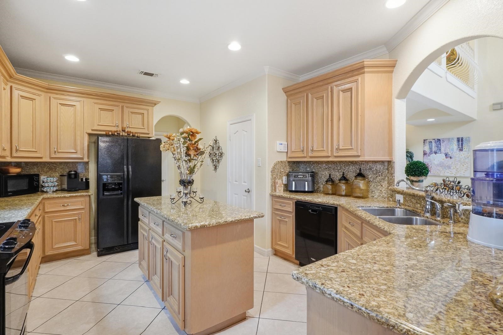 247 Old Spring Lane Houston, TX 77015 - Photo 4 of 25 a kitchen with stainless steel appliances granite countertop a sink dishwasher stove top oven and refrigerator