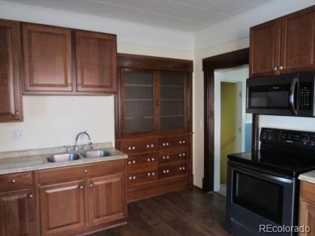 210 South 2nd Street Victor, CO 80860 - Photo 11 of 23 a kitchen with granite countertop wooden cabinets and stainless steel appliances