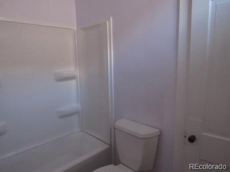 210 South 2nd Street Victor, CO 80860 - Photo 3 of 23 a bathroom with a shower and toilet