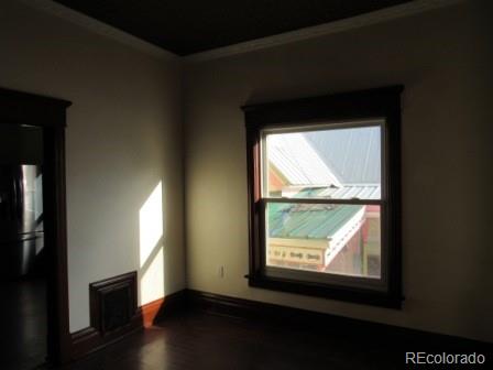 210 South 2nd Street Victor, CO 80860 - Photo 9 of 23 a view of an empty room with wooden floor and a window
