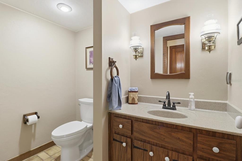 7310 South Irma Point Lecanto, FL 34461 - Photo 13 of 48 a bathroom with a toilet sink and mirror