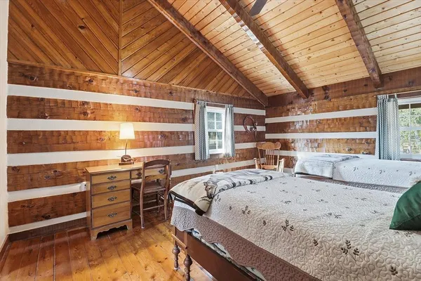 a bedroom with two beds and a table