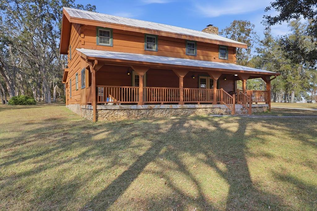 7310 South Irma Point Lecanto, FL 34461 - Photo 33 of 48 a front view of a house with a yard
