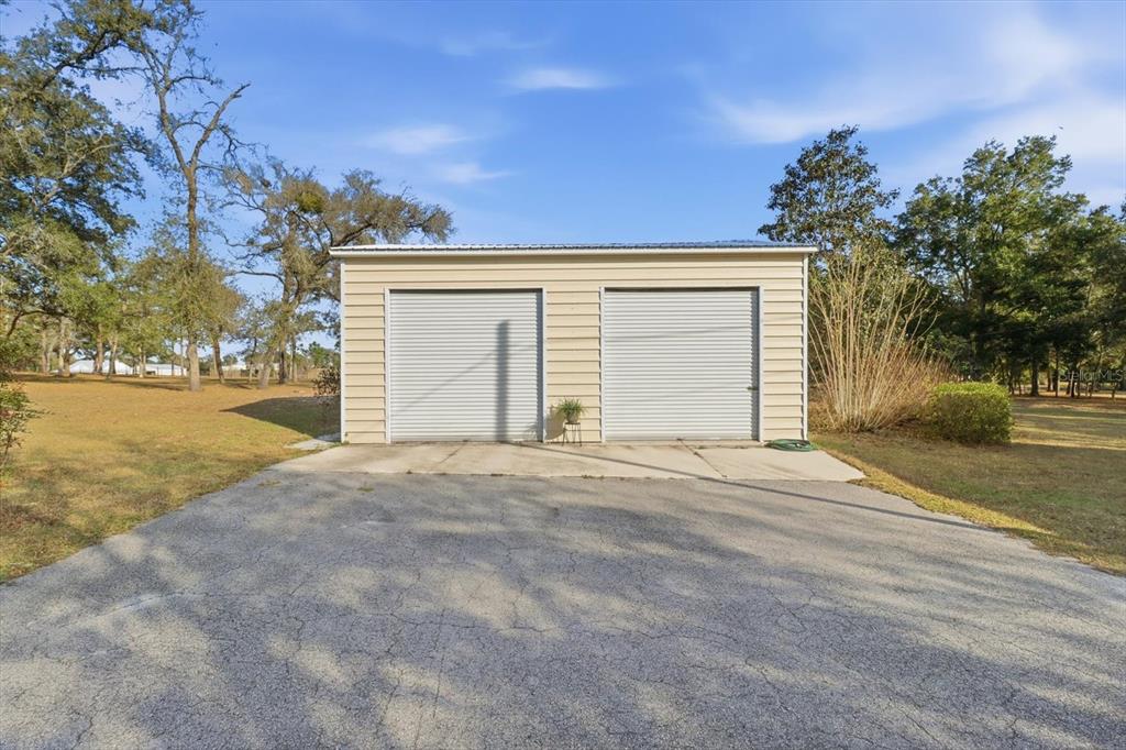 7310 South Irma Point Lecanto, FL 34461 - Photo 34 of 48 a front view of a house with a yard and garage