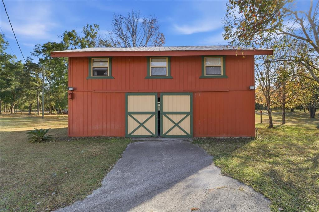 7310 South Irma Point Lecanto, FL 34461 - Photo 36 of 48 a front view of a house with a yard and garage