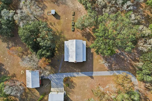 an aerial view of ocean and residential houses with outdoor space