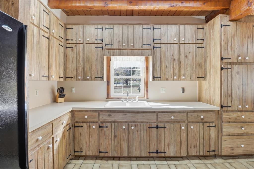 7310 South Irma Point Lecanto, FL 34461 - Photo 10 of 48 a kitchen with kitchen island granite countertop a sink cabinets and window