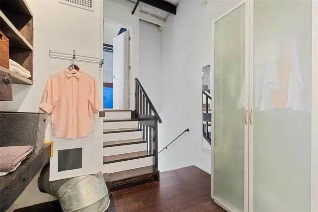 a view of entryway and hall with wooden floor