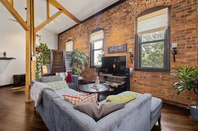 a living room with fireplace furniture and a flat screen tv