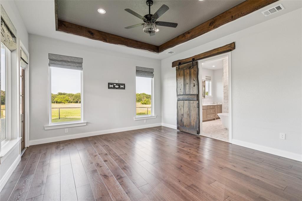 12877 Foutch Road Pilot Point, TX 76258 - Photo 19 of 40 a view of an empty room with a window and wooden floor