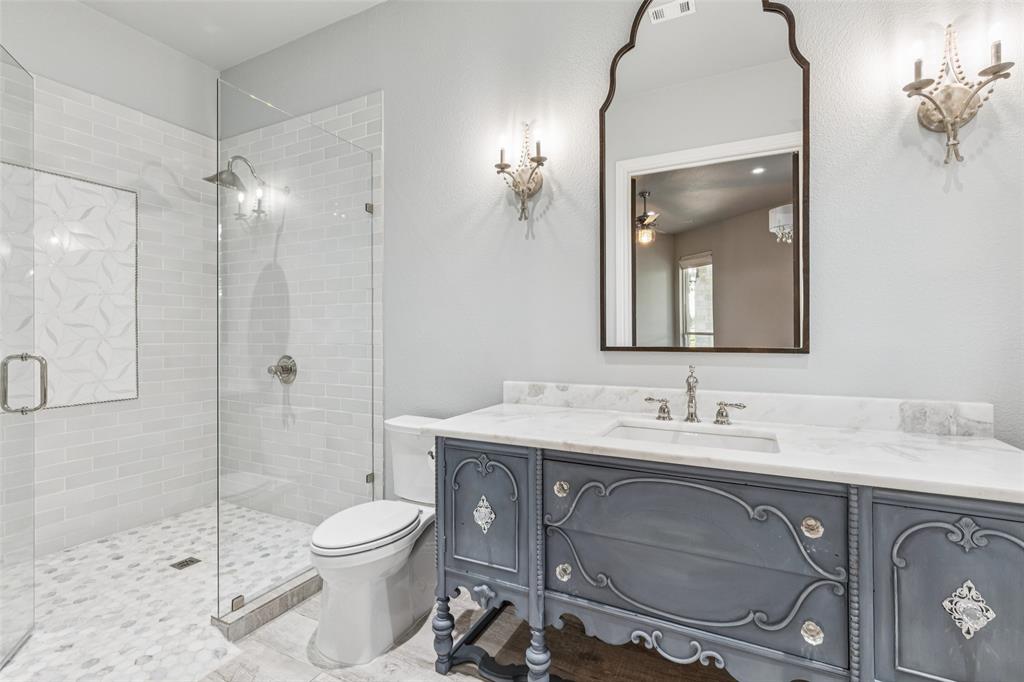 12877 Foutch Road Pilot Point, TX 76258 - Photo 27 of 40 a bathroom with a toilet a sink and shower