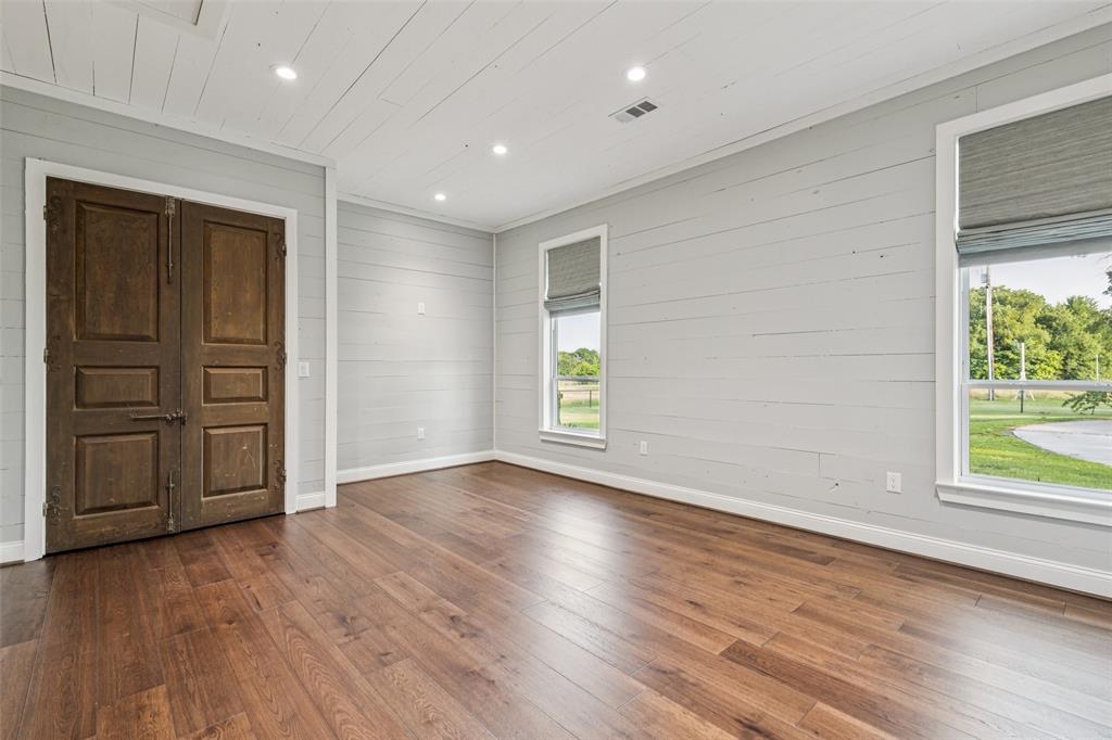 12877 Foutch Road Pilot Point, TX 76258 - Photo 28 of 40 an empty room with wooden floor and windows