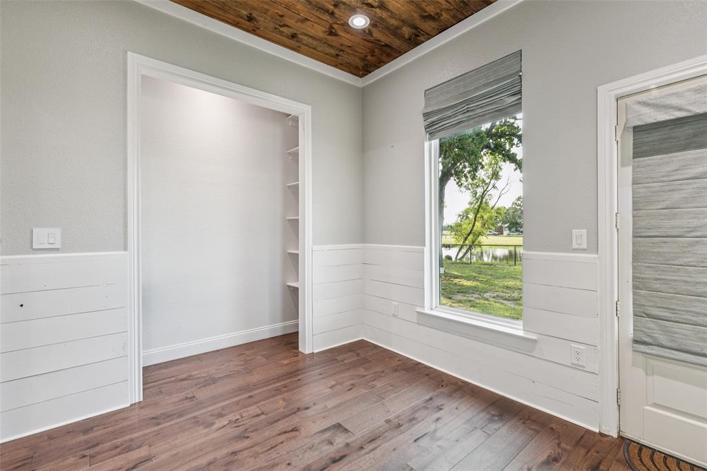 12877 Foutch Road Pilot Point, TX 76258 - Photo 30 of 40 an empty room with wooden floor and windows