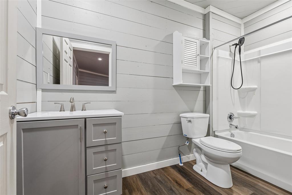 12877 Foutch Road Pilot Point, TX 76258 - Photo 32 of 40 a bathroom with a sink toilet and shower