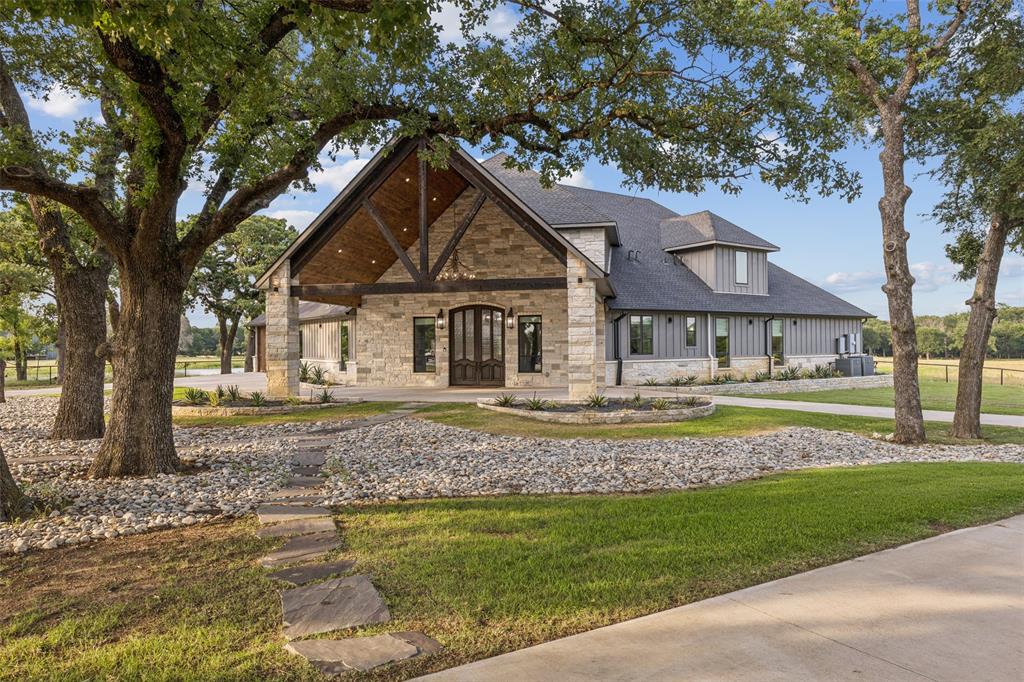 12877 Foutch Road Pilot Point, TX 76258 - Photo 4 of 40 a front view of a house with a garden