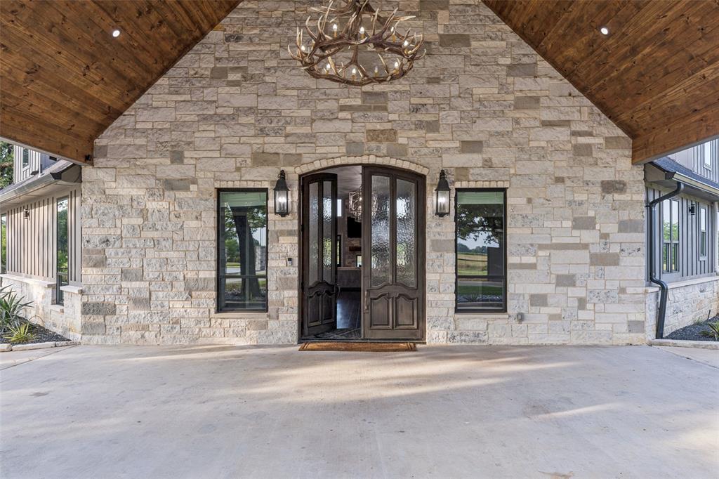 12877 Foutch Road Pilot Point, TX 76258 - Photo 5 of 40 a brick building with a view of front door