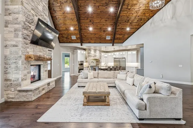 a view of a livingroom with couch wooden floor and windows
