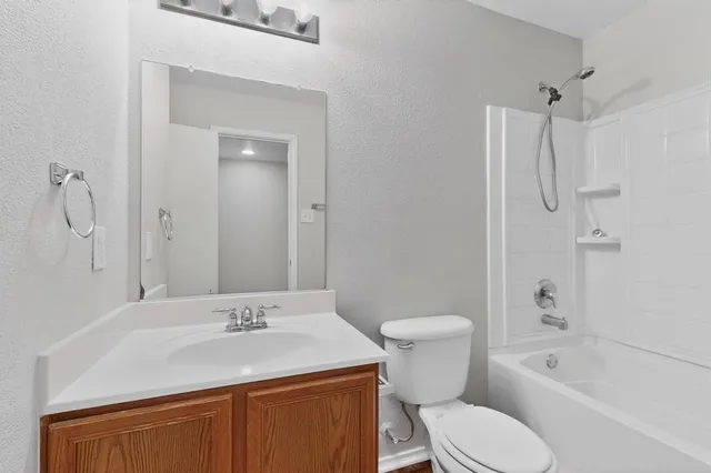 a bathroom with a sink toilet vanity and shower