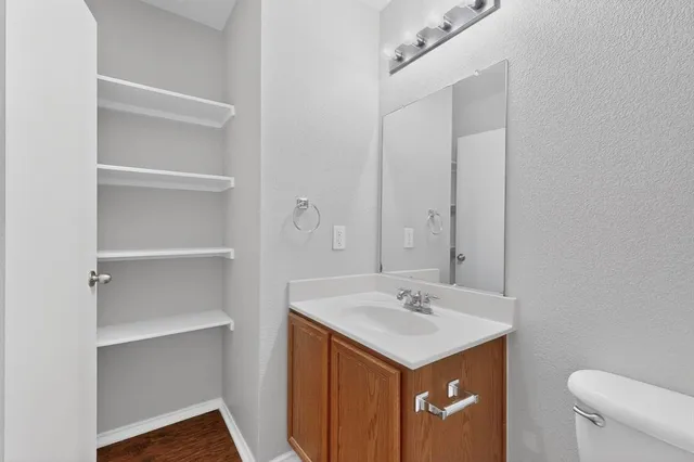 a bathroom with a sink toilet and a mirror